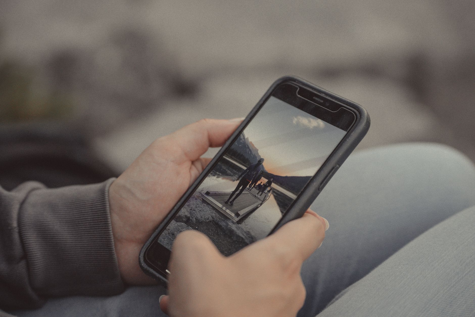 スマートフォンを両手で持つ人の写真(公式サイトが挙げる特徴)
