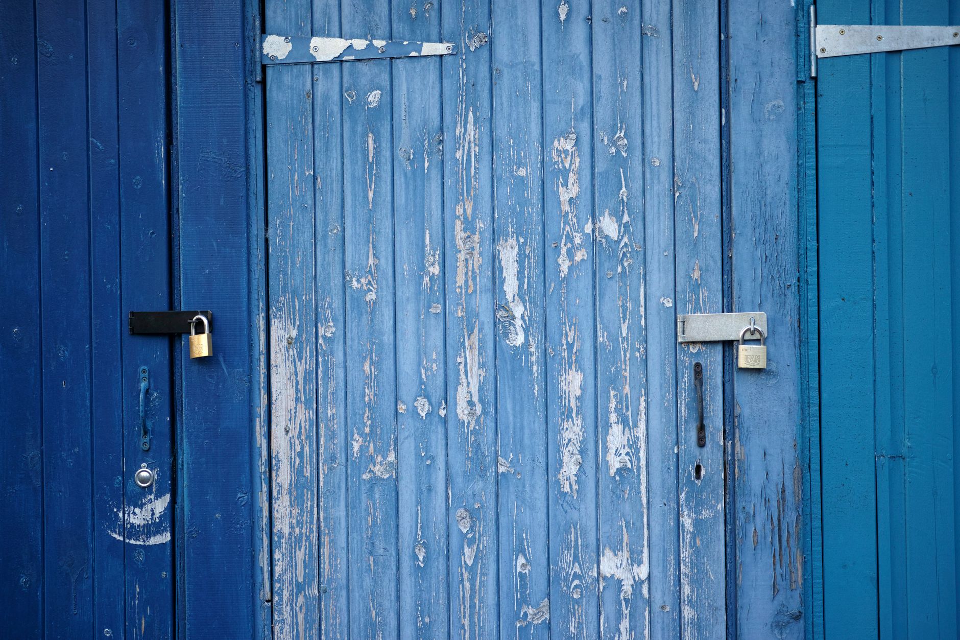 青い木の扉に取り付けられた南京錠の写真(セキュリティに関する公式の説明)